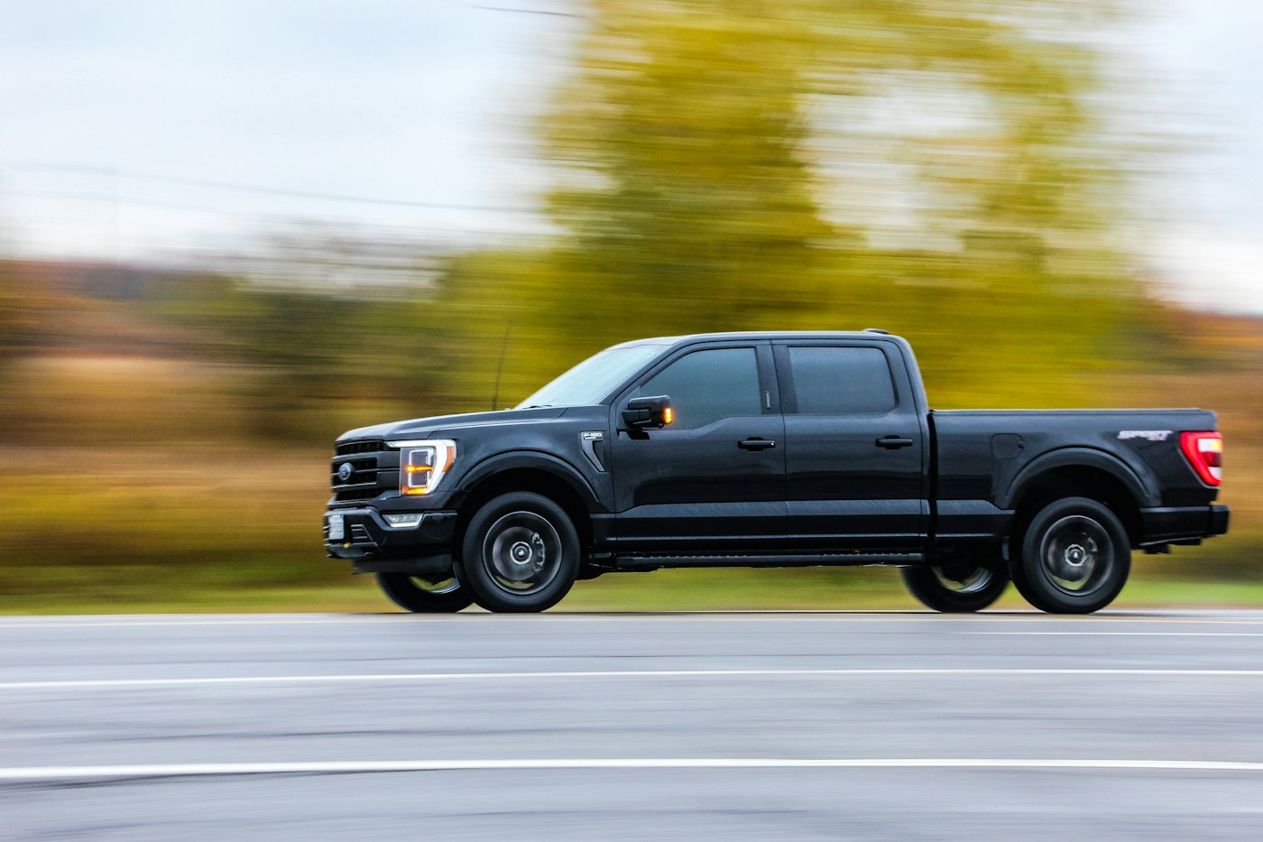 Black pickup truck driving on a highway